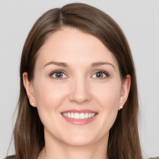 Joyful white young-adult female with long  brown hair and grey eyes