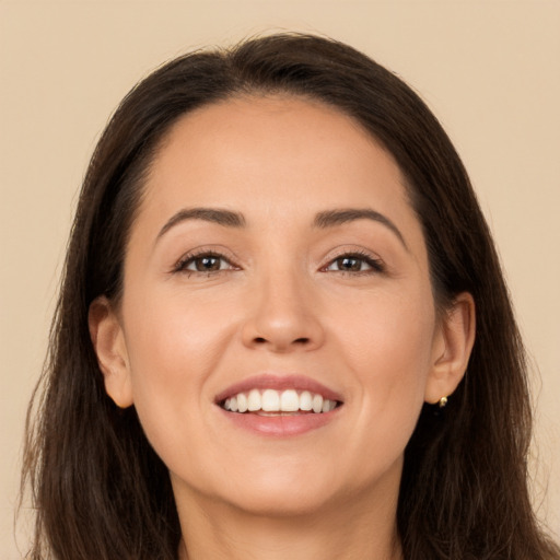 Joyful white young-adult female with long  brown hair and brown eyes