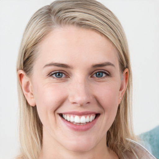 Joyful white young-adult female with long  brown hair and blue eyes