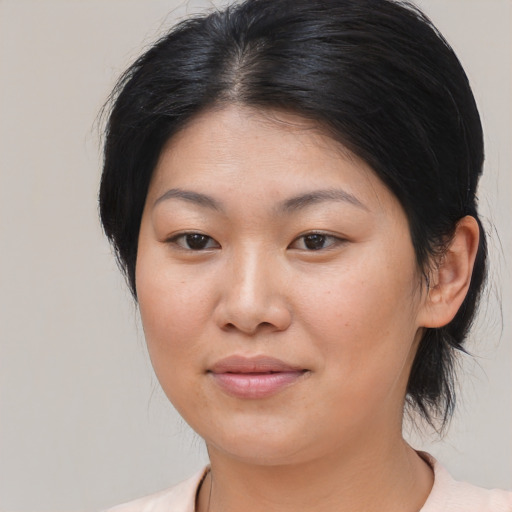 Joyful asian young-adult female with medium  black hair and brown eyes