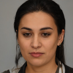 Joyful latino young-adult female with medium  brown hair and brown eyes