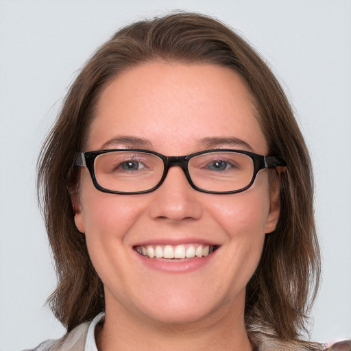 Joyful white young-adult female with medium  brown hair and blue eyes