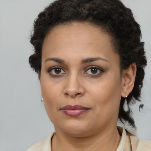 Joyful black young-adult female with medium  brown hair and brown eyes