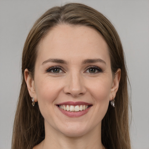 Joyful white young-adult female with long  brown hair and grey eyes