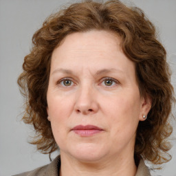 Joyful white adult female with medium  brown hair and blue eyes