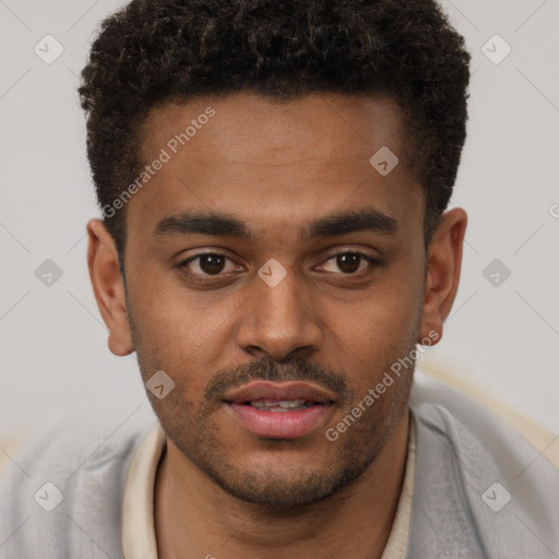 Joyful black young-adult male with short  brown hair and brown eyes