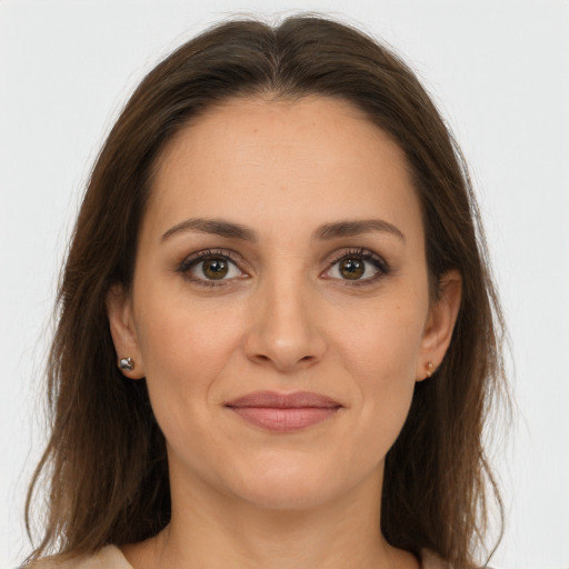 Joyful white young-adult female with long  brown hair and brown eyes