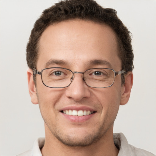 Joyful white adult male with short  brown hair and brown eyes