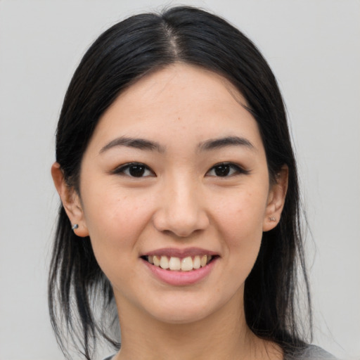 Joyful asian young-adult female with medium  black hair and brown eyes