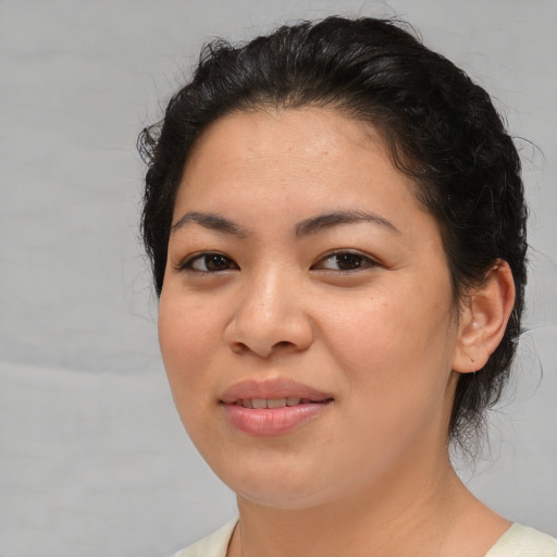 Joyful asian young-adult female with medium  black hair and brown eyes