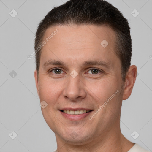 Joyful white adult male with short  brown hair and brown eyes