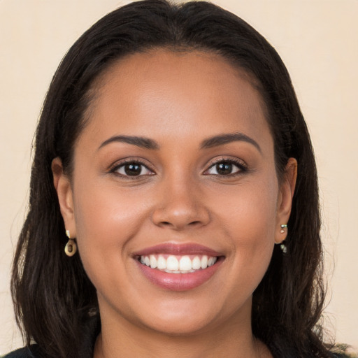 Joyful white young-adult female with long  brown hair and brown eyes