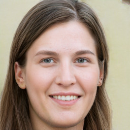 Joyful white young-adult female with long  brown hair and green eyes