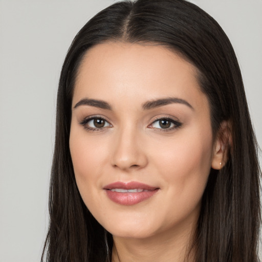 Joyful white young-adult female with long  black hair and brown eyes