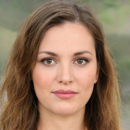 Joyful white young-adult female with long  brown hair and green eyes