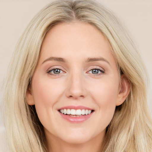 Joyful white young-adult female with long  brown hair and blue eyes