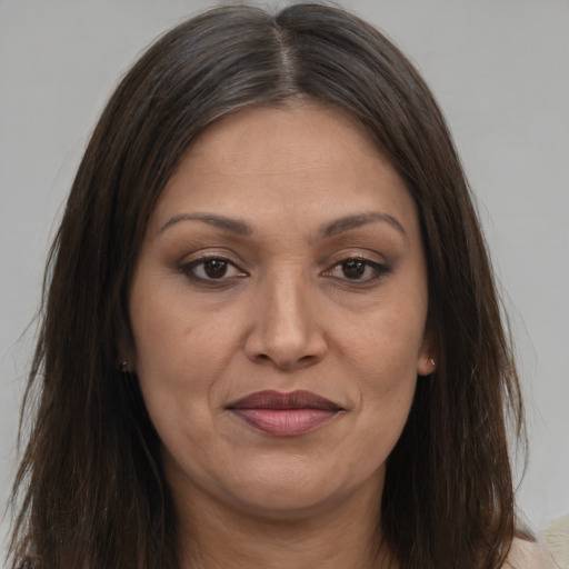 Joyful white adult female with long  brown hair and brown eyes
