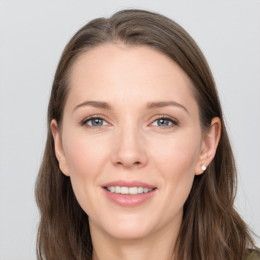 Joyful white young-adult female with long  brown hair and grey eyes