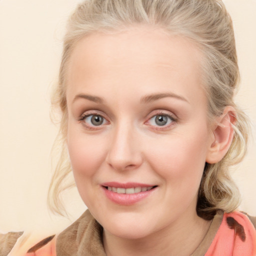 Joyful white young-adult female with medium  brown hair and blue eyes