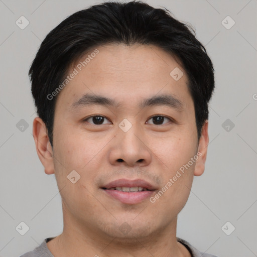 Joyful asian young-adult male with short  brown hair and brown eyes