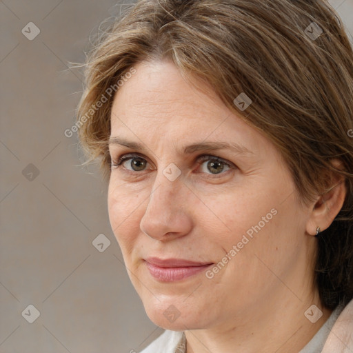 Joyful white adult female with medium  brown hair and brown eyes