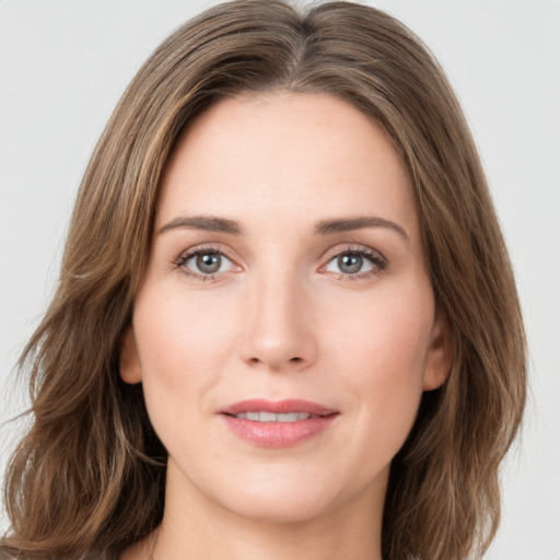 Joyful white young-adult female with long  brown hair and green eyes