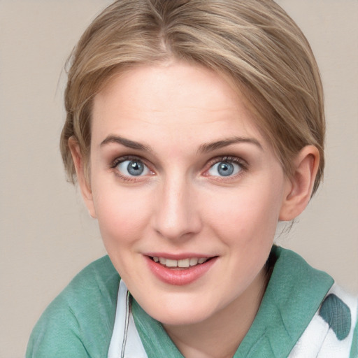 Joyful white young-adult female with medium  brown hair and blue eyes