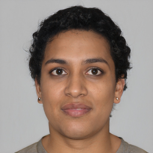 Joyful latino young-adult female with short  black hair and brown eyes