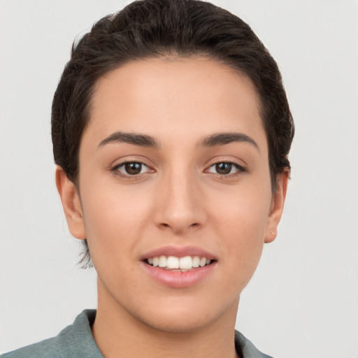 Joyful white young-adult female with short  brown hair and brown eyes