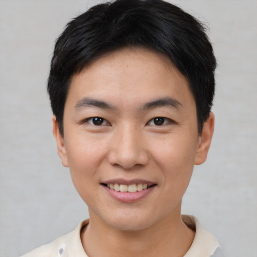 Joyful asian young-adult male with short  black hair and brown eyes