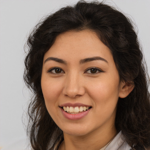 Joyful asian young-adult female with long  brown hair and brown eyes