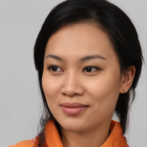 Joyful asian young-adult female with medium  black hair and brown eyes