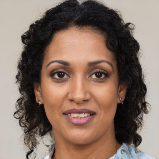 Joyful black young-adult female with medium  brown hair and brown eyes