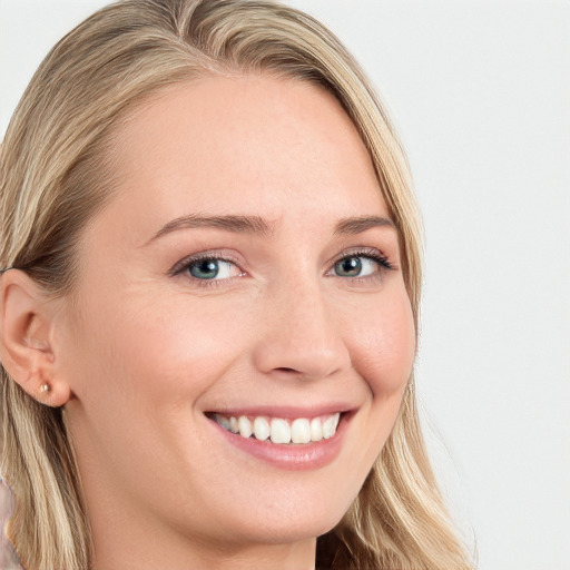 Joyful white young-adult female with long  brown hair and blue eyes