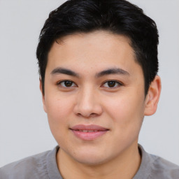 Joyful asian young-adult male with short  brown hair and brown eyes