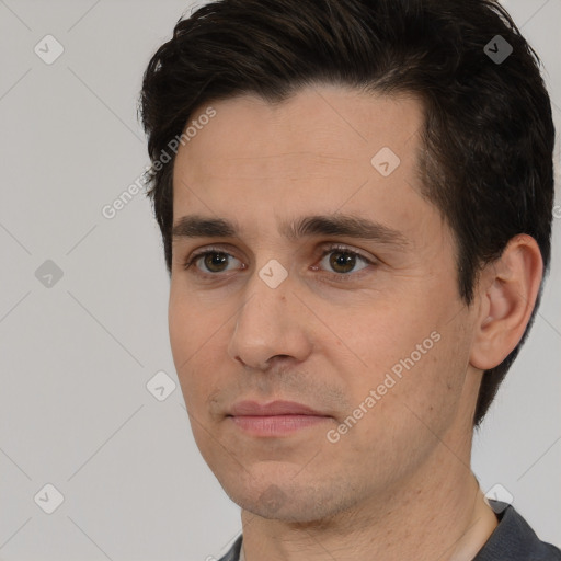 Joyful white young-adult male with short  black hair and brown eyes