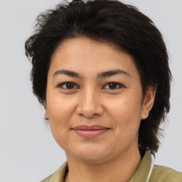 Joyful white adult female with medium  brown hair and brown eyes