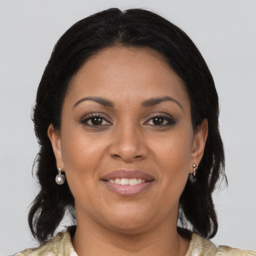 Joyful black adult female with medium  brown hair and brown eyes