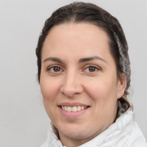 Joyful white adult female with medium  brown hair and brown eyes