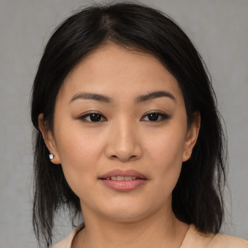 Joyful asian young-adult female with medium  black hair and brown eyes