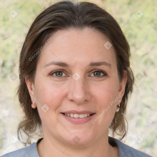 Joyful white adult female with medium  brown hair and grey eyes