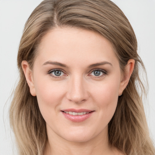 Joyful white young-adult female with long  brown hair and grey eyes