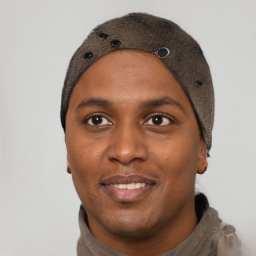 Joyful black young-adult male with short  black hair and brown eyes