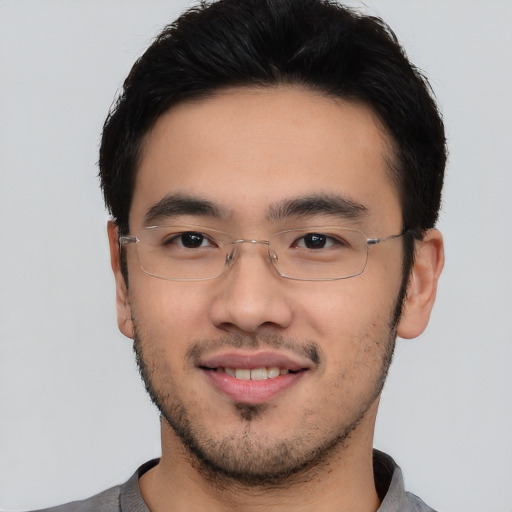 Joyful asian young-adult male with short  brown hair and brown eyes