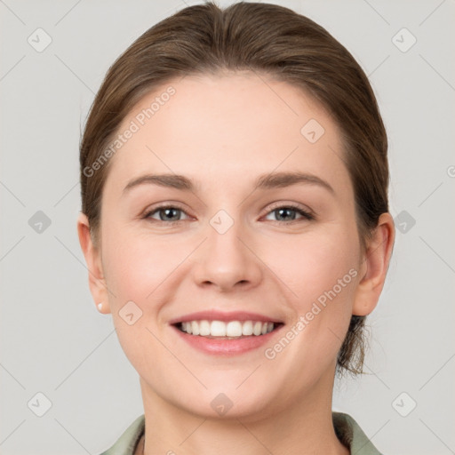 Joyful white young-adult female with medium  brown hair and grey eyes