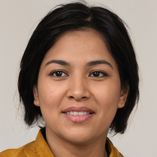 Joyful asian adult female with medium  brown hair and brown eyes