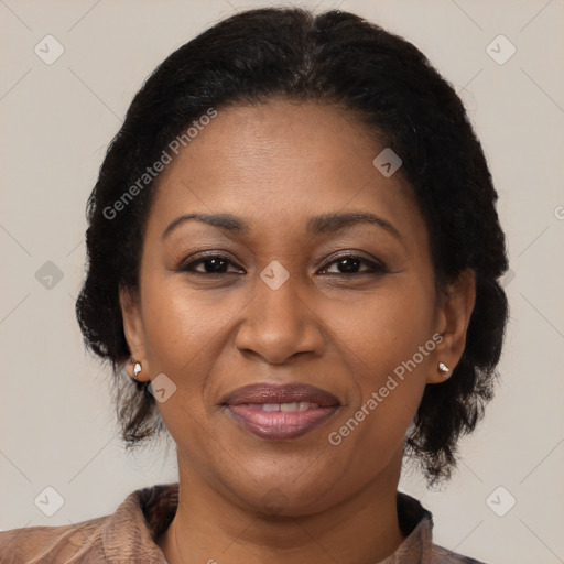 Joyful black adult female with short  brown hair and brown eyes