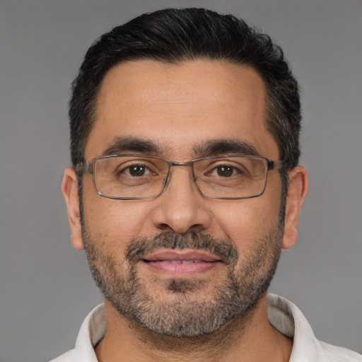 Joyful white adult male with short  black hair and brown eyes