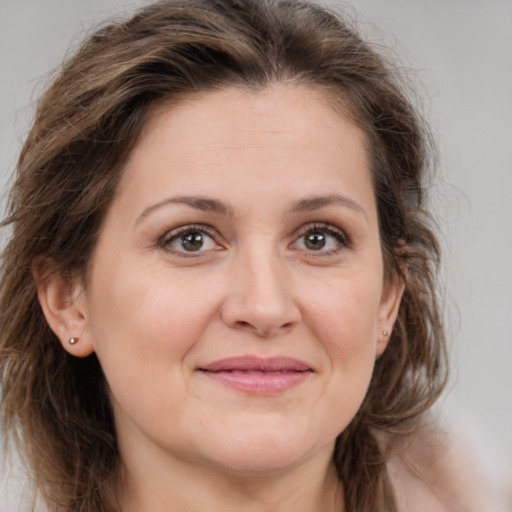 Joyful white adult female with medium  brown hair and brown eyes