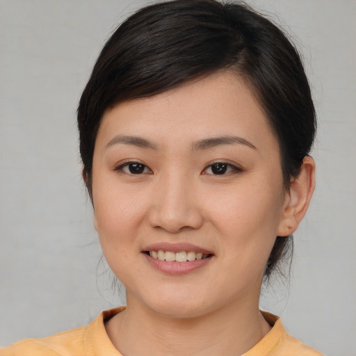 Joyful white young-adult female with medium  brown hair and brown eyes